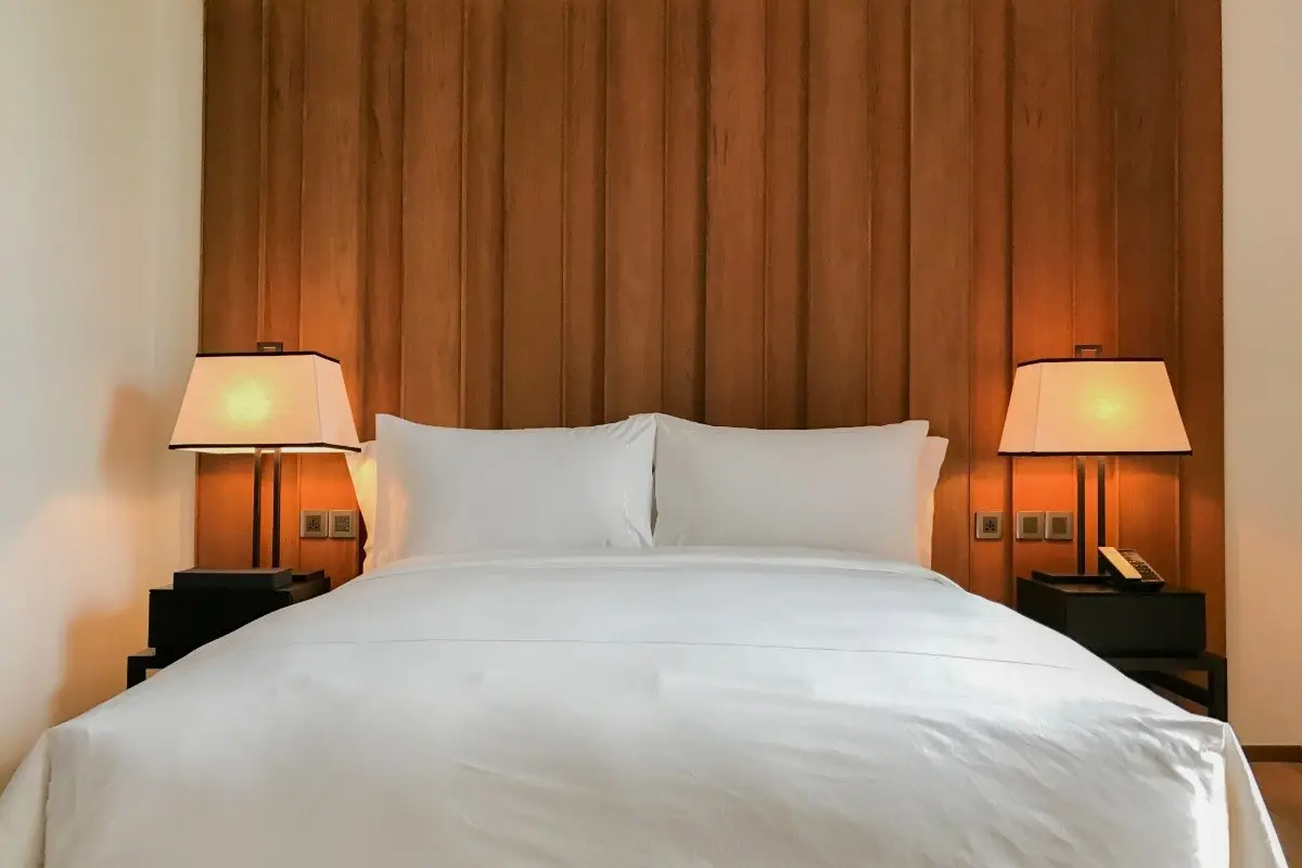 Bedroom demonstrating feng shui interior design with a bed in the commanding position and symmetrical nightstands