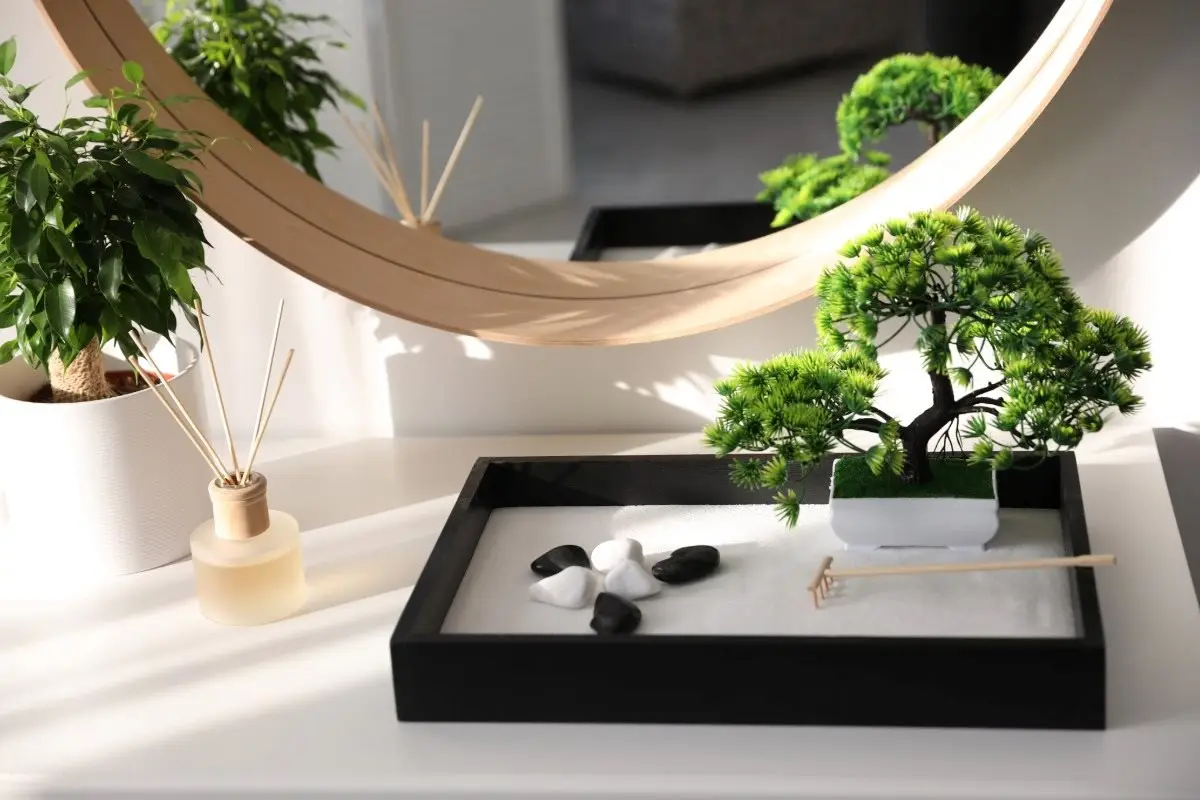 A calming Japanese Zen garden gift for a desk or home, designed for mindfulness and stress relief with its raked sand, stones, and miniature rake.
