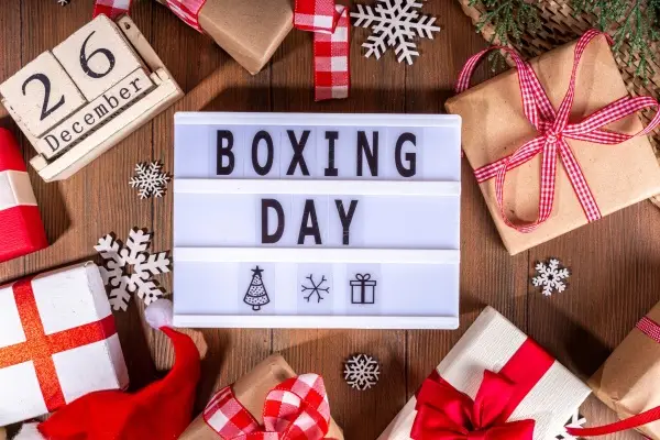 Light-up sign on a shelf that says "BOXING DAY" with snowflakes and gifts around.