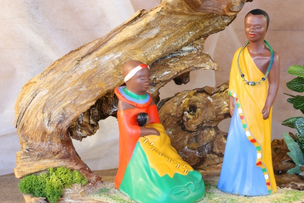 A Nativity scene with colorful figurines of Mary, Joseph, and the Baby Jesus.