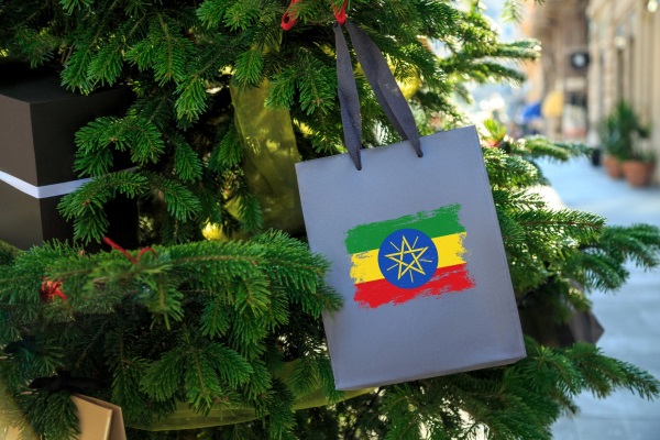 Grey shopping bag with an Ethiopian flag design hanging on a Christmas tree.