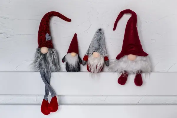 Four decorative Scandinavian-style gnomes with long beards and conical hats.